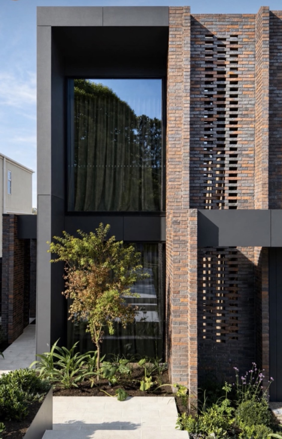 Architectural Home — Dark Steel & Open-Joint Brick Facade